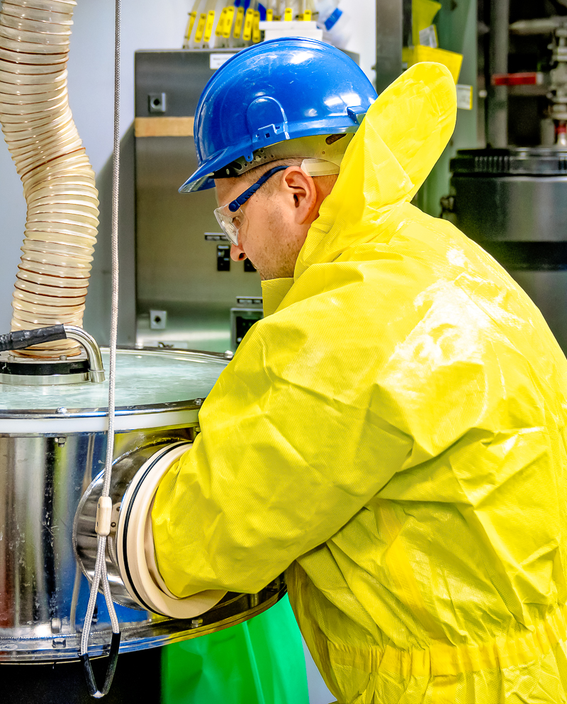 Production team member in yellow protective suit